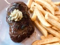 Juicy grilled steak with herb butter and french fries.