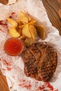 Juicy grilled steak, potatoes and ketchup Royalty Free Stock Photo