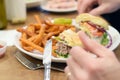 Juicy half eaten cheeseburger on plate Royalty Free Stock Photo