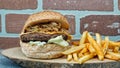 Juicy hamburger with caramelized onions and frech fries