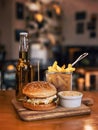 Juicy hamburger served with fries Royalty Free Stock Photo
