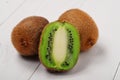 Juicy kiwi fruit on white wooden background Royalty Free Stock Photo