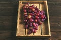 Juicy large bunch of grapes in a wooden box close-up. Ripe grapes and copy space. An abundance of grapes with grape seed