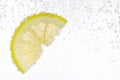 Juicy lemon slice in soda water against white background, closeup. Space for text Royalty Free Stock Photo