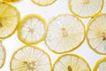 Juicy lemon slices with bubbles under water isolated on white background. Yellow lemon slices pattern textured background Royalty Free Stock Photo