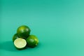 Juicy limes on a green background