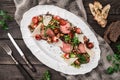 Juicy medium beef fillet steaks mignon with grilled vegetables, mushrooms, tomatoes, cheese in plate on rustic wooden background Royalty Free Stock Photo