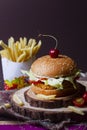 Juicy mexican burger, hamburger or cheeseburger with one chicken patties, with sauce,french fries and cold drink. Concept of Royalty Free Stock Photo