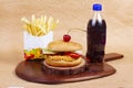 Juicy mexican burger, hamburger or cheeseburger with one chicken patties, with sauce,french fries and cold drink. Concept of Royalty Free Stock Photo