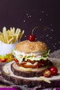 Juicy mini snack burger, hamburger or cheeseburger with one chicken patties, with sauce and french fries . Concept of American Royalty Free Stock Photo