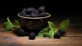 Juicy mulberries with green leaves in the bowl. Ripe and fresh berries. Concept of raw food, nature's candy Royalty Free Stock Photo