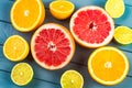 Juicy oranges, grapefruits, limes and lemons lie on a blue wooden table. view from above Royalty Free Stock Photo