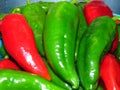 Juicy organic green and red peppers close up photo. Peppers covered with water drops. Royalty Free Stock Photo