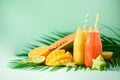 Juicy papaya and pineapple, mango, orange fruit smoothie in two jars on turquoise background. Detox, summer diet food Royalty Free Stock Photo