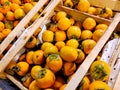 Juicy persimmons lie on the counter in a fruit store Royalty Free Stock Photo