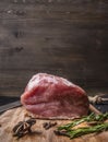 Juicy piece of fresh raw pork steak on a cutting board with rosemary, cloves Dittany place for text
