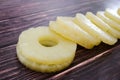 Yellow juicy pineapple rings. Caramelized canned pineapple. Raw food diet. Close-up plan. Woody background. Royalty Free Stock Photo