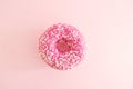 Juicy Pink Sprinkled Donut on a Pink Background