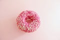 Juicy Pink Sprinkled Donut on a Pink Background