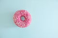 Juicy Pink Sprinkled Donut isolated on a Blue Background