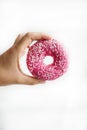 Juicy Pink Sprinkled Donut on a White Background