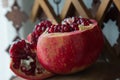 Juicy pomegranate fruit on a wooden support. Royalty Free Stock Photo