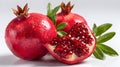 Juicy pomegranate and its half with leaves Royalty Free Stock Photo