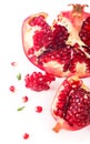 Juicy pomegranate and its half with leaves. Isolated on a white background. Royalty Free Stock Photo