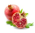 Juicy pomegranate and its half with leaves. Isolated on a white background. Royalty Free Stock Photo