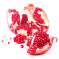 Juicy pomegranate and its half with leaves. Isolated on a white background. Royalty Free Stock Photo