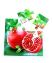 Juicy pomegranate and its half with leaves photo on puzzle boards Royalty Free Stock Photo