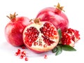 Juicy pomegranate and its half with leaves Royalty Free Stock Photo