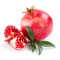 Juicy pomegranate and its half with leaves Royalty Free Stock Photo