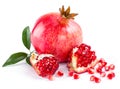 Juicy pomegranate and its half with leaves Royalty Free Stock Photo