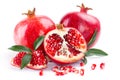 Juicy pomegranate and its half with leaves Royalty Free Stock Photo