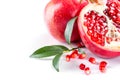 Juicy pomegranate and its half with leaves Royalty Free Stock Photo