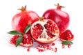 Juicy pomegranate and its half with leaves Royalty Free Stock Photo