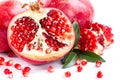 Juicy pomegranate and its half with leaves Royalty Free Stock Photo