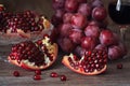 Juicy pomegranate with red grape and red wine. Still life with pomegranate. Royalty Free Stock Photo