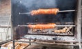 Juicy pork meat cooking on outdoor rotisserie