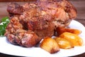 Juicy pork neck chops are grilled with potatoes on a white plate. Royalty Free Stock Photo