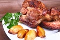 Juicy pork neck chops are grilled with potatoes on a white plate. Royalty Free Stock Photo