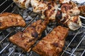 Juicy Pork steak, ribs and chicken meat on bbq grill, homemade barbecue, closeup Royalty Free Stock Photo