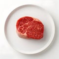 Juicy Raw Beef Steak Elegantly Displayed on a White Plate Against Solid White Background Royalty Free Stock Photo