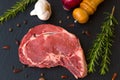Juicy raw meat, beef entrecote on black background, top view