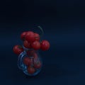 Juicy red cherry tomatoes in a jug on a sharp black background, capturing the freshness of a healthy diet in a still life in an