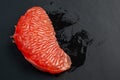 Juicy red grapefruit on black background Royalty Free Stock Photo