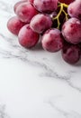 Juicy red grapes on a marble background Royalty Free Stock Photo