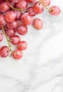 Juicy red grapes on a marble background Royalty Free Stock Photo