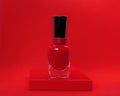 Juicy red nail Polish on red background. The concept of hand care, advertising manicure salon, manufacturer of nail polishes, Royalty Free Stock Photo